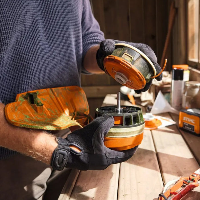 person changing STIHL FSA 70 R Battery Grass Trimmer AK System Kit at Cannings. A versatile battery grass trimmer kit with battery and charger for trimming, mowing and clean-up work.
